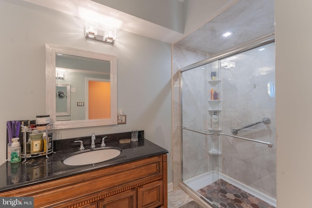 bathroom with vanity and a shower with shower door