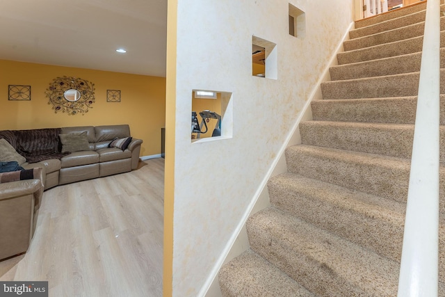 staircase with wood-type flooring