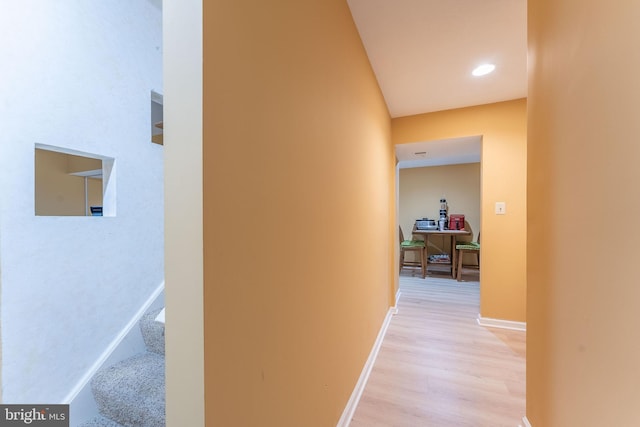 hallway with light hardwood / wood-style flooring