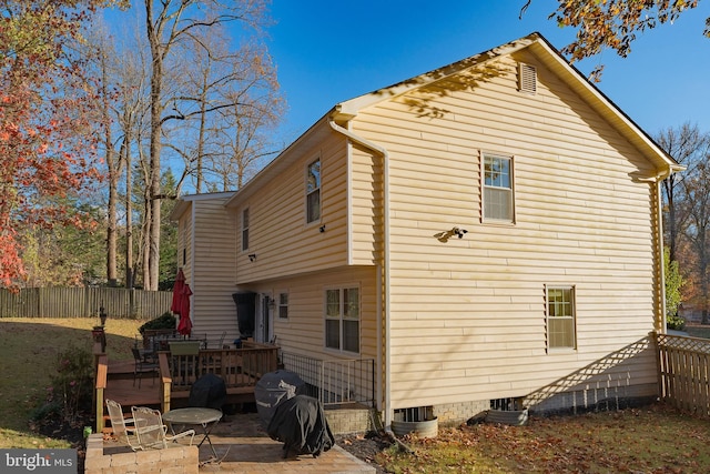 rear view of property featuring a patio and a wooden deck