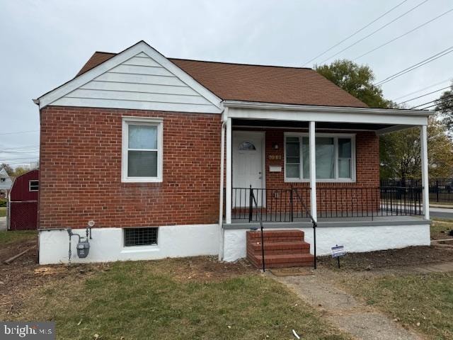 bungalow with a porch and a front yard