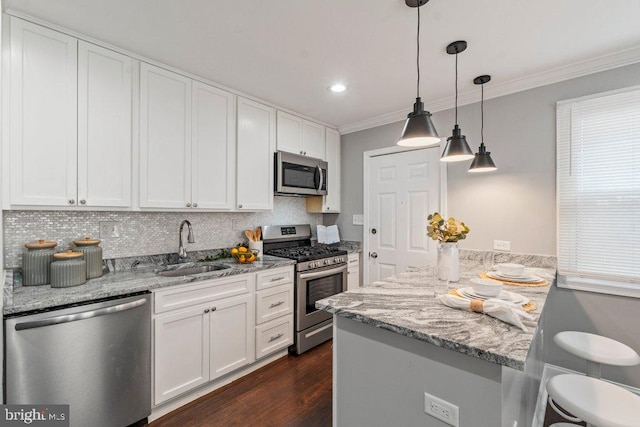 kitchen with white cabinetry, sink, crown molding, pendant lighting, and appliances with stainless steel finishes