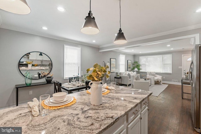 kitchen with white cabinetry, stainless steel refrigerator, a wealth of natural light, and dark wood-type flooring