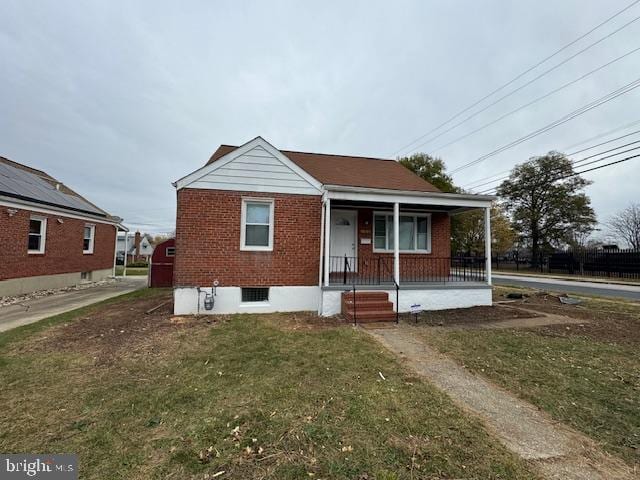 bungalow with a porch and a front yard