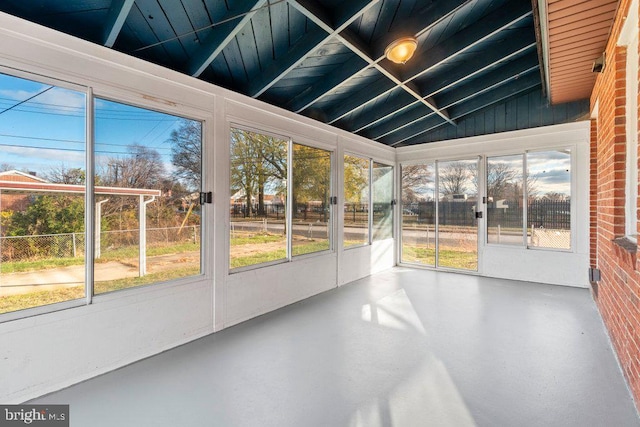 unfurnished sunroom with vaulted ceiling