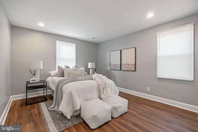 bedroom with dark wood-type flooring