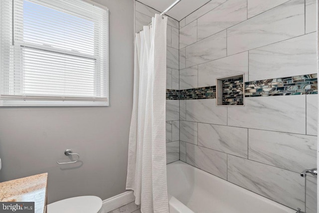 bathroom featuring shower / bath combo and toilet