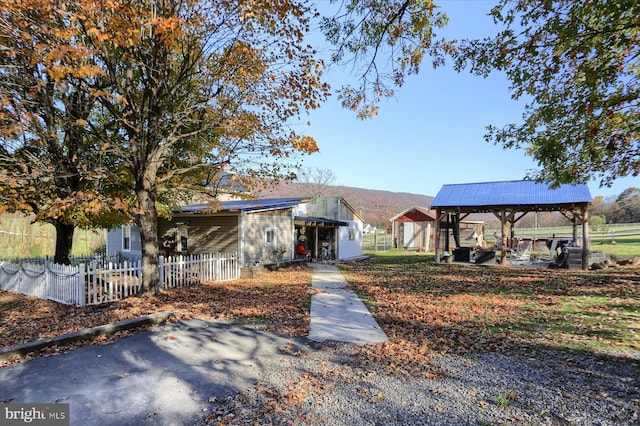 view of front of house with a gazebo and an outdoor structure