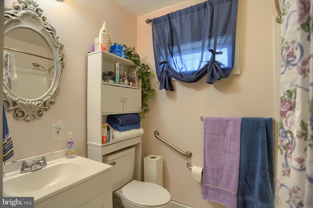 bathroom featuring vanity and toilet