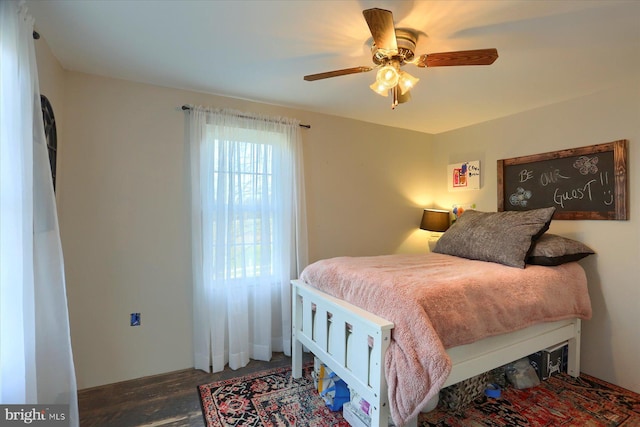 bedroom with ceiling fan and dark hardwood / wood-style floors