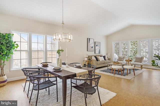 dining room featuring lofted ceiling and a chandelier