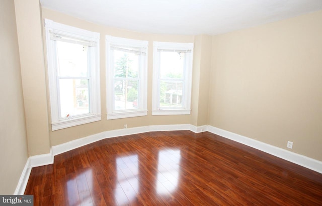 unfurnished room with wood-type flooring