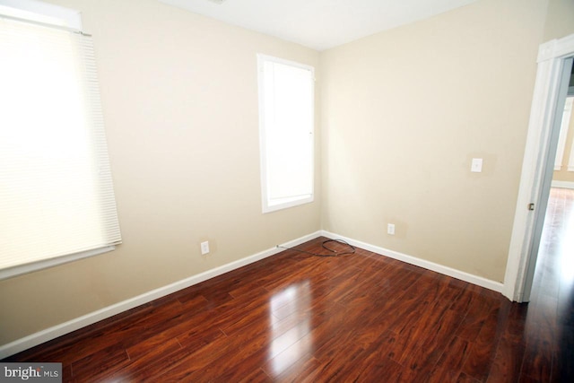 unfurnished room featuring dark hardwood / wood-style flooring