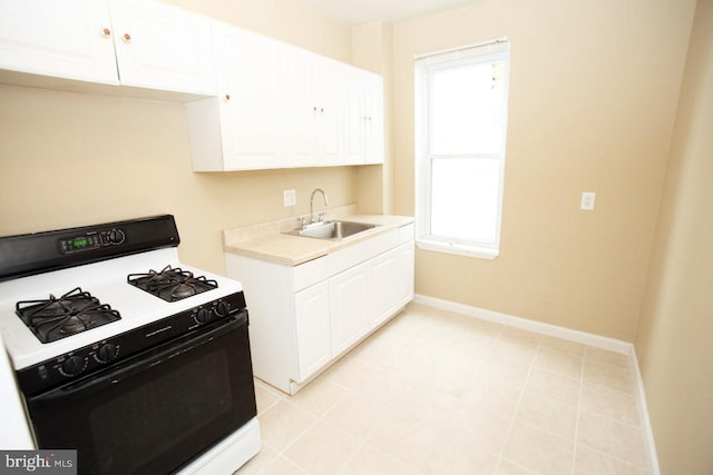 kitchen with white cabinets, sink, white gas range oven, and a wealth of natural light