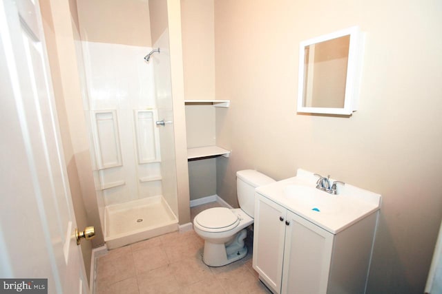 bathroom with a shower, vanity, tile patterned floors, and toilet