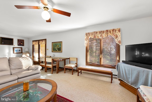 living room featuring ceiling fan, light colored carpet, and a wall mounted air conditioner