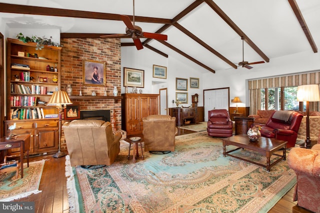 living room featuring hardwood / wood-style floors, ceiling fan, beam ceiling, and a fireplace