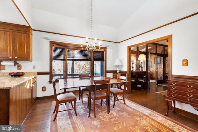 dining room featuring hardwood / wood-style floors, high vaulted ceiling, and an inviting chandelier