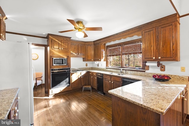 kitchen featuring kitchen peninsula, light stone counters, ornamental molding, dark wood-type flooring, and black appliances