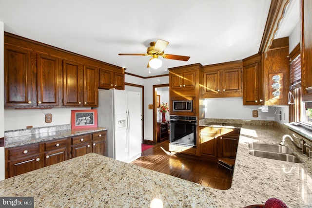 kitchen with stainless steel microwave, oven, sink, white fridge with ice dispenser, and dark hardwood / wood-style flooring