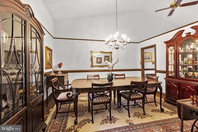 dining room with hardwood / wood-style floors, ceiling fan with notable chandelier, and lofted ceiling