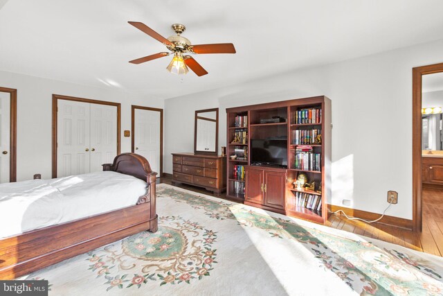 14445 Kings Grant Ln, Doswell, VA 23047 - bedroom featuring multiple closets, wood finished floors, ensuite bathroom, ceiling fan, and baseboards