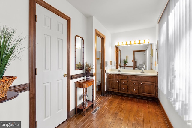 bathroom featuring vanity, toilet, and wood-type flooring