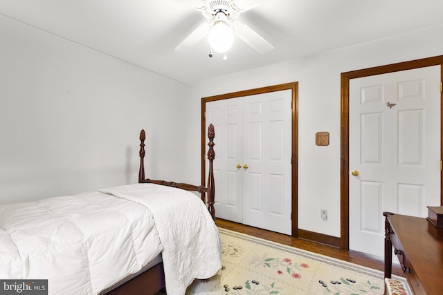 bedroom featuring a closet, ceiling fan, and dark wood-type flooring