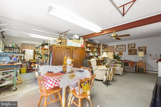 dining room with a baseboard radiator, a wall unit AC, ceiling fan, and light colored carpet