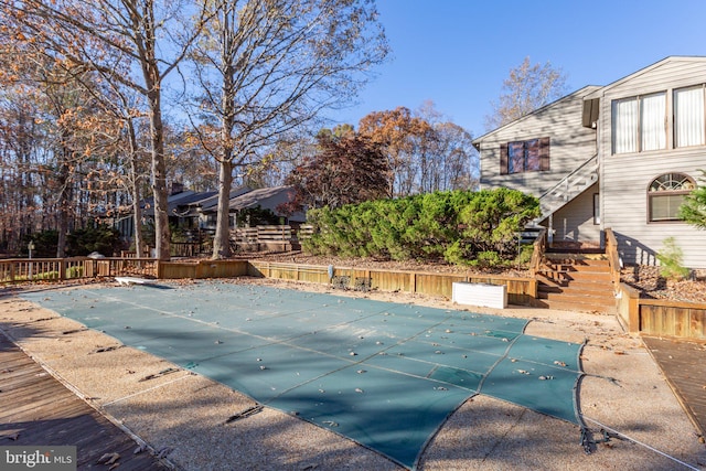 view of pool featuring a diving board