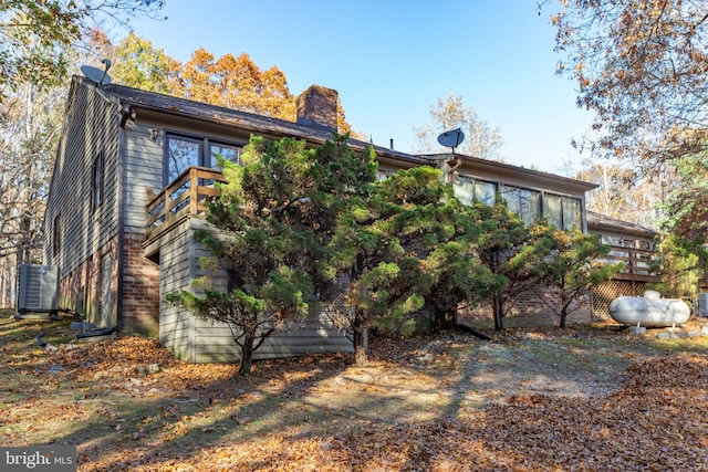 back of property with cooling unit and a deck