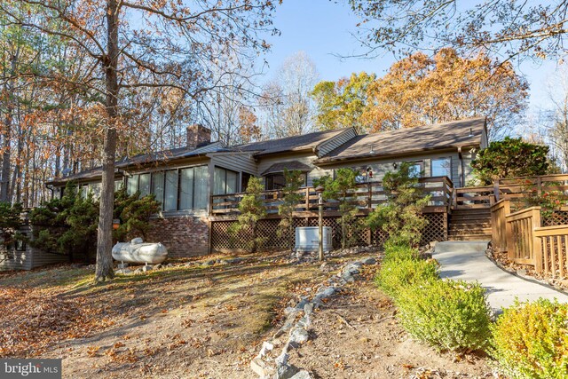 14445 Kings Grant Ln, Doswell, VA 23047 - view of front of house featuring a sunroom, a wooden deck, and a chimney