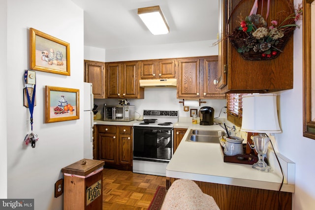 14445 Kings Grant Ln, Doswell, VA 23047 - kitchen with range with electric stovetop, light countertops, under cabinet range hood, a sink, and brown cabinets