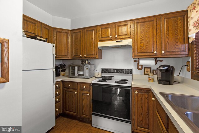 14445 Kings Grant Ln, Doswell, VA 23047 - kitchen featuring range with electric cooktop, freestanding refrigerator, under cabinet range hood, stainless steel microwave, and light countertops