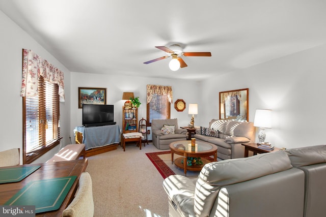 carpeted living room with ceiling fan