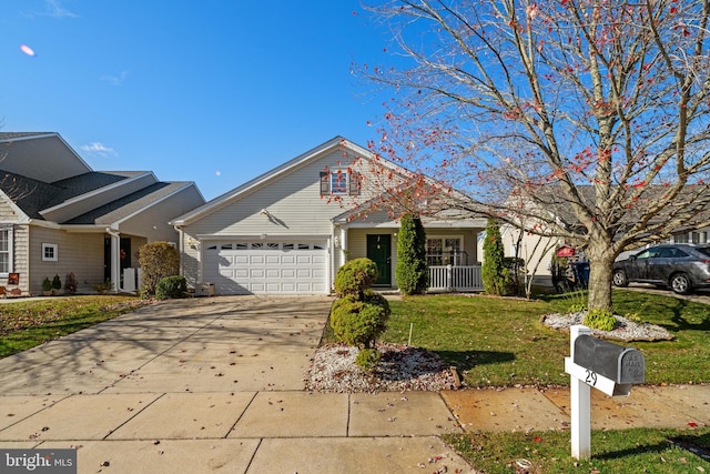 view of front of house with covered porch, a garage, and a front lawn