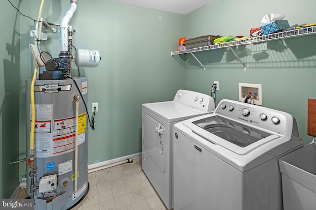 washroom featuring separate washer and dryer, sink, and gas water heater