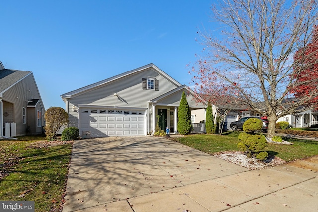 view of front facade with a garage and a front lawn