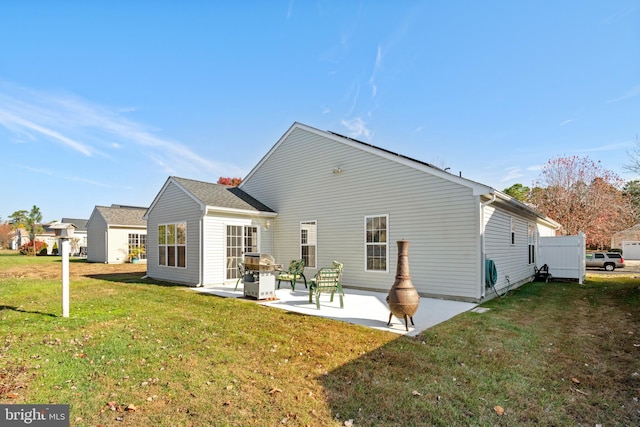 back of house featuring a patio and a lawn