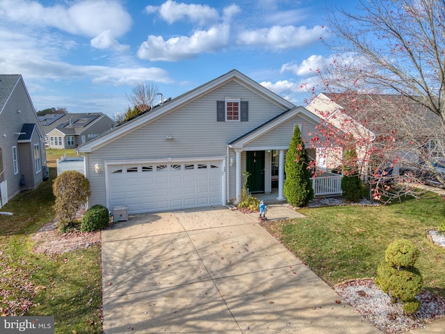 view of front of property with a porch, a garage, and a front yard