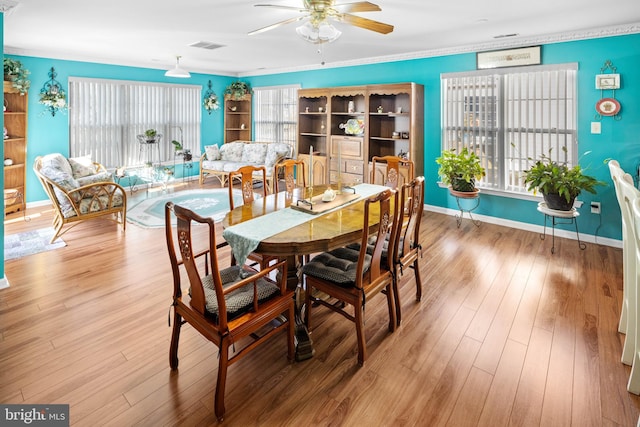 dining room with ceiling fan, wood-type flooring, and ornamental molding