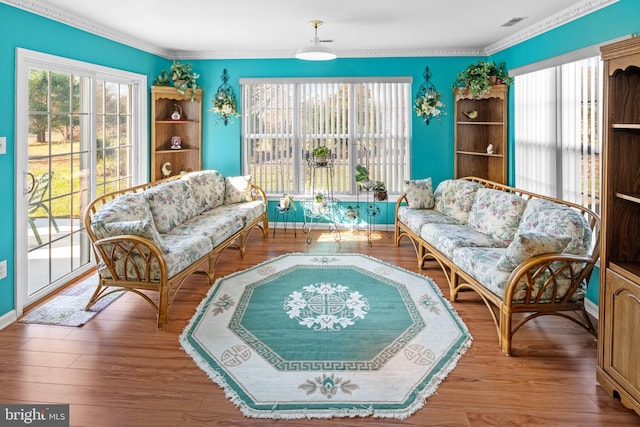 sitting room featuring light hardwood / wood-style floors and crown molding