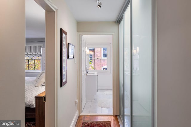 hallway with light hardwood / wood-style floors