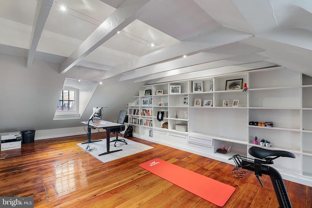 exercise area featuring built in shelves and hardwood / wood-style flooring