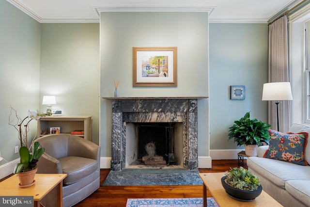 living room featuring a high end fireplace, dark wood-type flooring, crown molding, and plenty of natural light