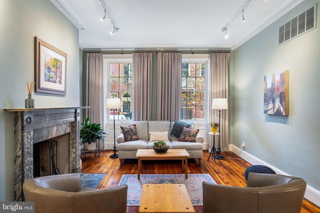 living room featuring ornamental molding, a premium fireplace, and hardwood / wood-style floors