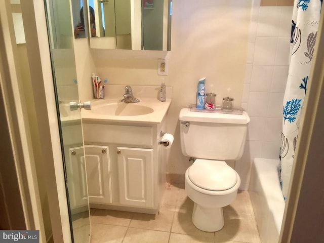 full bathroom with tile patterned floors, shower / bathtub combination with curtain, vanity, and toilet