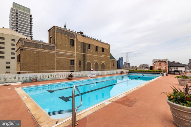 view of swimming pool with a patio area