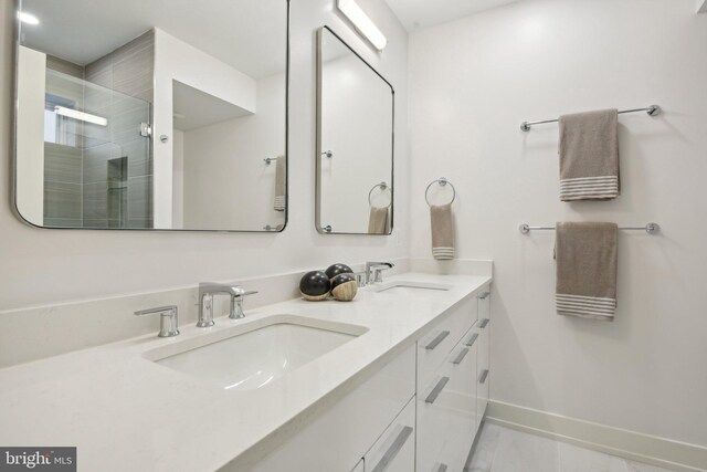 bathroom with a shower with door and vanity