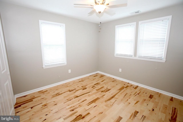 spare room featuring hardwood / wood-style flooring and ceiling fan